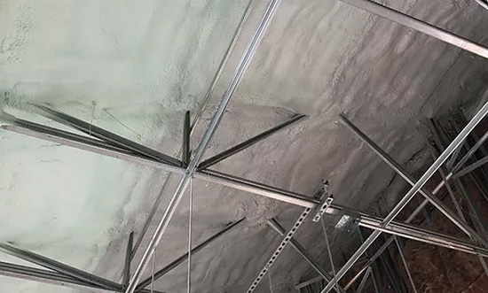 Spray foam insulation on a ceiling with exposed metal framework.