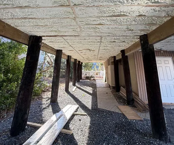 Closed cell spray foam insulation applied to the underside of an elevated home for moisture protection and energy efficiency.